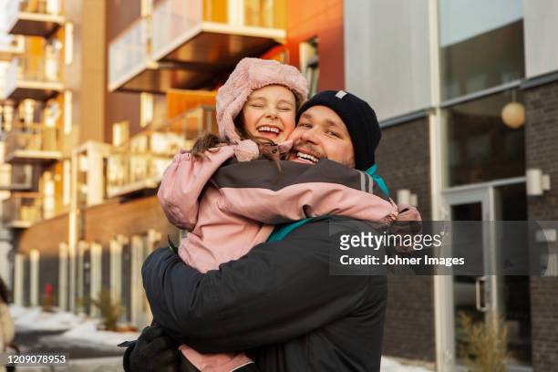 father and daughter hugging - warm clothing stock pictures, royalty-free photos & images