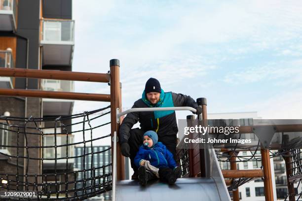 father with son on slide - carriage stock pictures, royalty-free photos & images