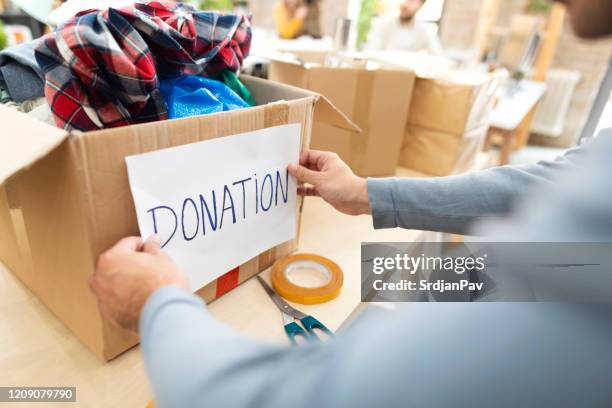 making a good deed - clothing donation stock pictures, royalty-free photos & images