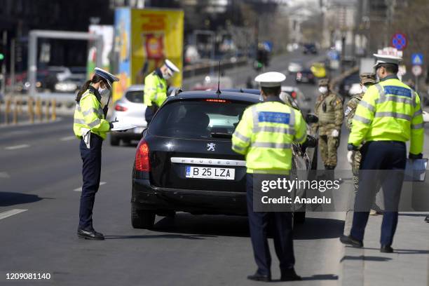 View of The police men and Srmy men stop the cars to check the driver's documents in the Union Square, in central Bucharest, Romania, 03 April 2020....