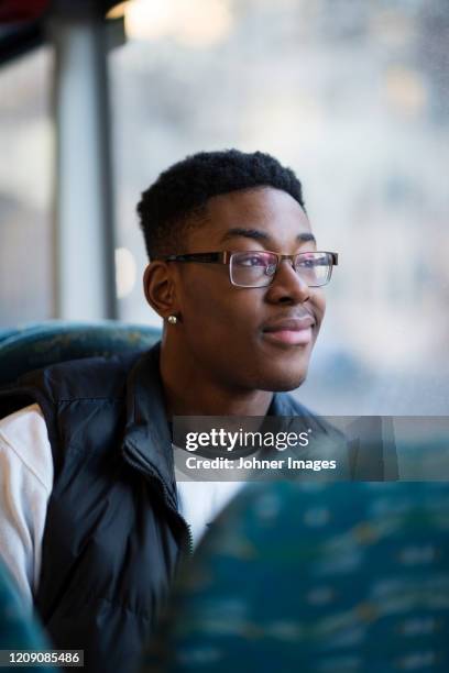 smiling man in bus looking away - teenage boy looking out window stock pictures, royalty-free photos & images