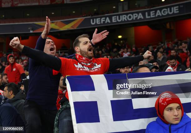 Olympiacos FC fans cheer prior to the UEFA Europa League round of 32 second leg match between Arsenal FC and Olympiacos FC at Emirates Stadium on...