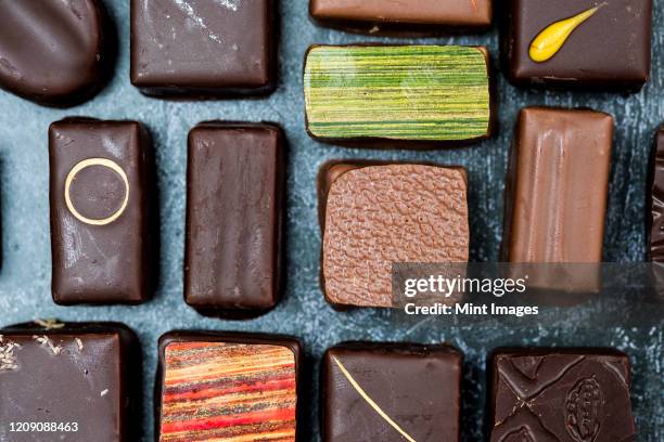 high angle close up of a selection of chocolate pralines. - milk chocolate stock pictures, royalty-free photos & images