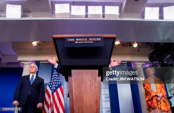 President Donald Trump gestures over the lectern as he speaks, flanked by Health and Human Services Secretary Alex Azar, US Vice President Mike Pence...