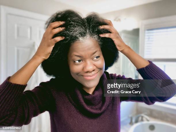 woman embraces growing gray hair - hair growth stock pictures, royalty-free photos & images