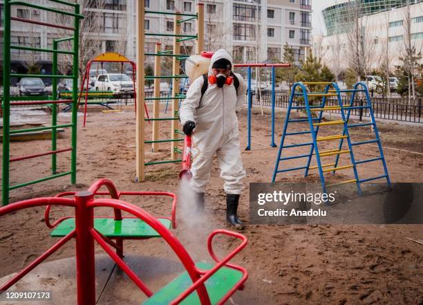 Crews disinfect streets, stations and public places within measures taken against the spreading of coronavirus pandemic in Nur Sultan, Kazakhstan on...