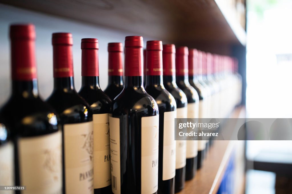 Wine bottles on shelf at a winery