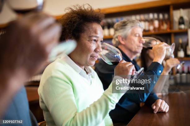 senior female tasting wine in a winery - taste test stock pictures, royalty-free photos & images