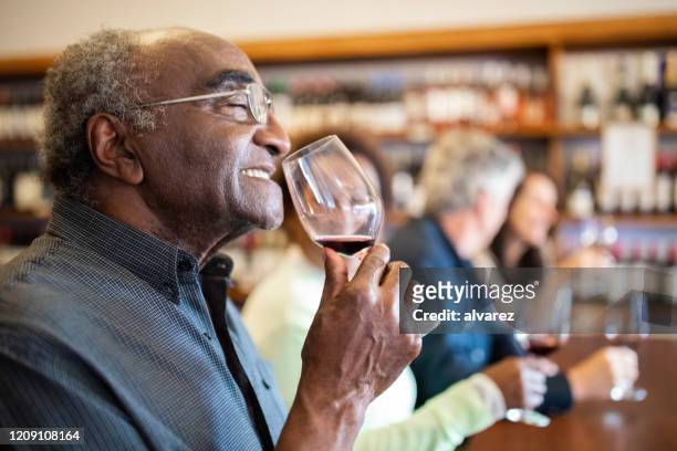 senior man at wine tasting. - cellar stock pictures, royalty-free photos & images