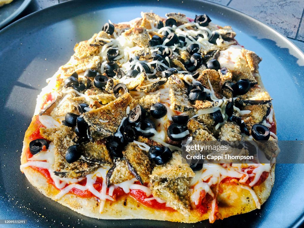 Homemade eggplant and olive pizza ready to eat