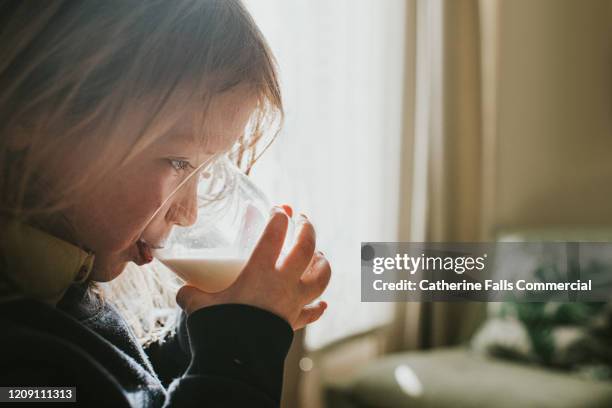 girl drinking milk - drinking milk foto e immagini stock