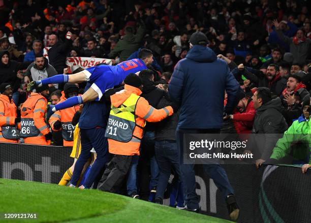 Olympiacos FC celebrate their sides second goal with their fans during the UEFA Europa League round of 32 second leg match between Arsenal FC and...