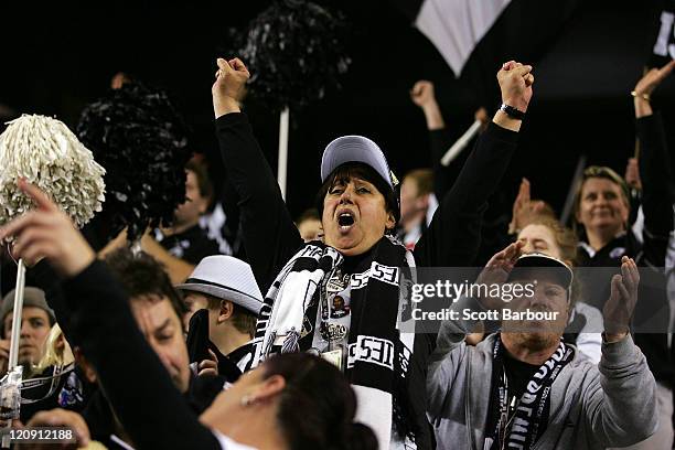 Members of the Collingwood cheer squad show their support during the round 21 AFL match between the St Kilda Saints and the Collingwood Magpies at...