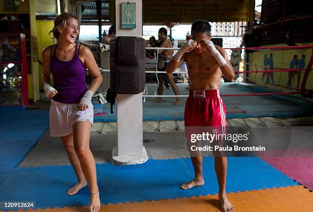 Dana Cleary from Tasmania, Australia gets instruction from Tak, a Thai kickboxing instructor, in a Muay Thai kickboxing class at the Sor. Vorapin...
