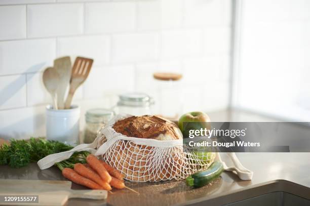 fresh bread, organic vegetables and fruit on a plastic free zero waste kitchen worktop. - kitchen bench wood stock-fotos und bilder