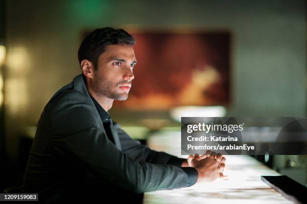 man sitting alone at bar counter. - expatriate stock pictures, royalty-free photos & images