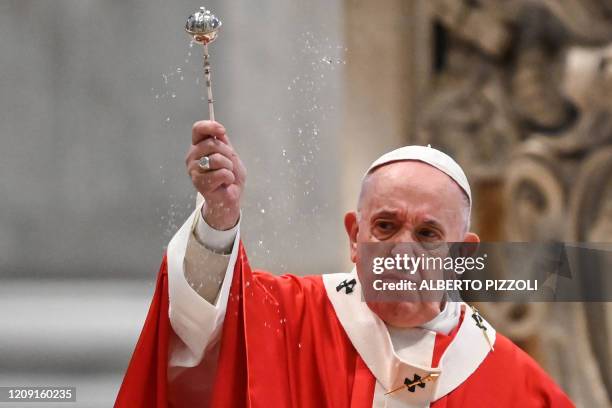 Pope Francis blesses attendees as he celebrates Palm Sunday behind closed doors in St. Peter's Basilica mass on April 5, 2020 in The Vatican, during...