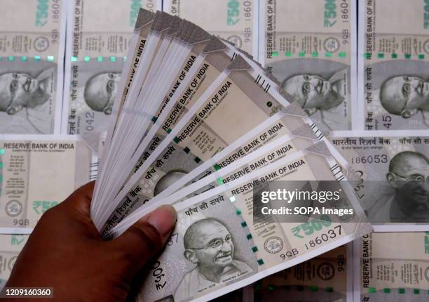 In this photo illustration Five hundred Rupee notes are seen on display.