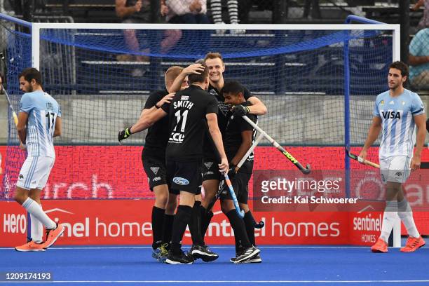 Dylan Thomas of New Zealand is congratulated by team mates after scoring a goal during the FIH Pro League match between the New Zealand Black Sticks...