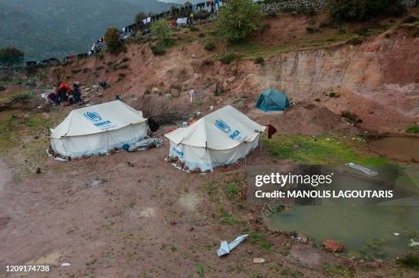 Migrants from sub-Saharan African countries who arrived on the island of Lesbos five days ago, remain in quarantine in an open space designated by...