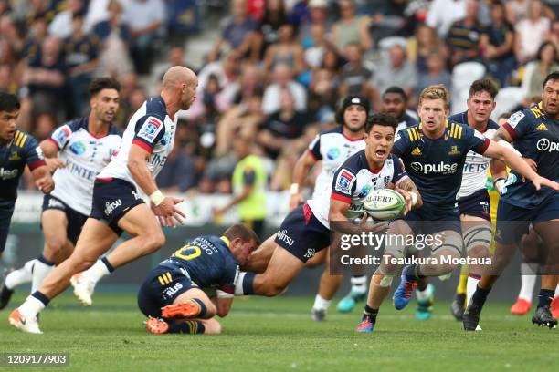 Matt Toomua of the Rebels passes during the round five Super Rugby match between the Highlanders and the Rebels at Forsyth Barr Stadium on February...