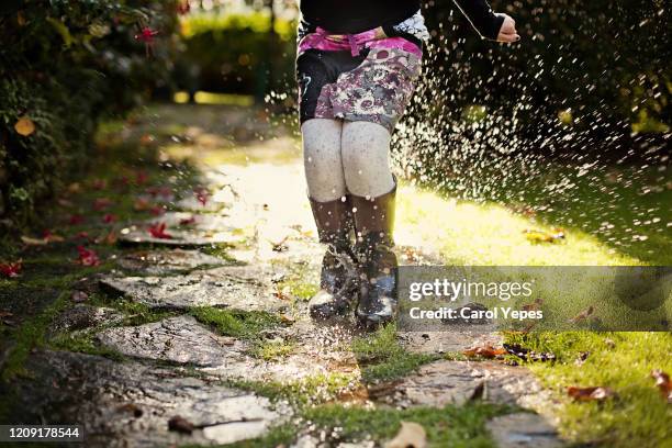 low section  playing puddles - rain garden stock pictures, royalty-free photos & images