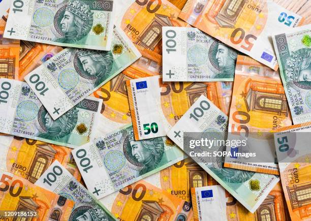 In this photo illustration a one hundred Polish Zloty and a fifty Euro banknotes.