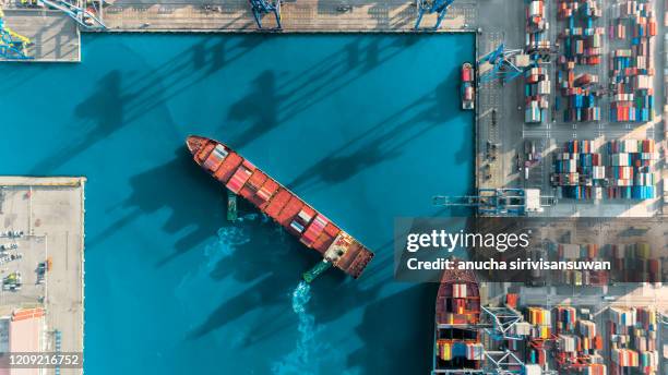 aerial top view container ship crane lifting container for logistic by sea in warehouse. - ship funnel ストックフォトと画像