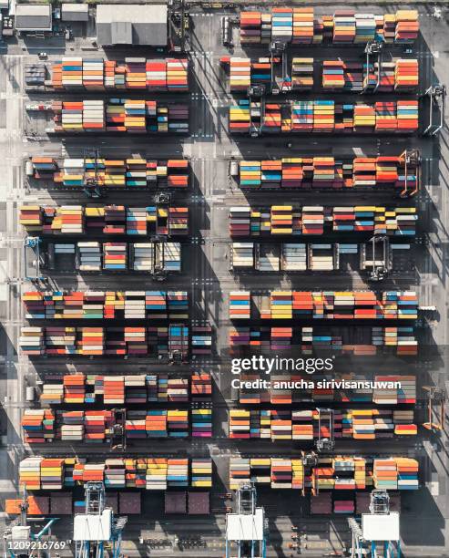 aerial top view container ship crane lifting container for logistic by sea in warehouse. - shipping container top view - fotografias e filmes do acervo