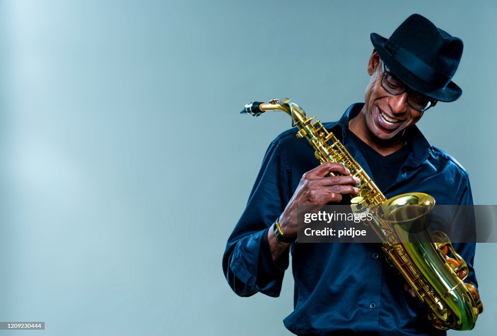Musician with saxophone and big smile