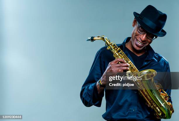 musician with saxophone and big smile - saxophone stock pictures, royalty-free photos & images