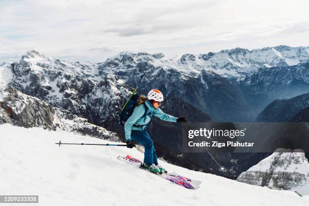 woman free ride skiing down the snowy mountain - ski touring stock pictures, royalty-free photos & images