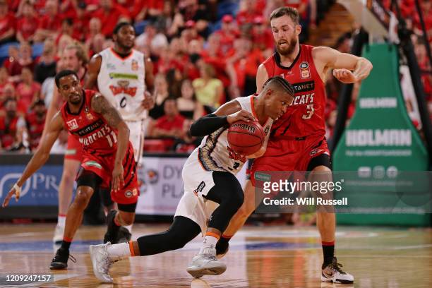 Scott Machado of the Taipans runs into the defense from Nick Kay of the Wildcats during game one of the NBL Semi Finals Series between the Perth...