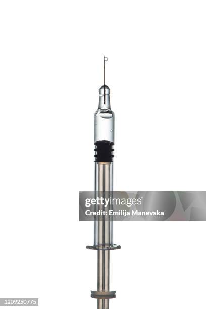 close-up of syringe against white background - portrait studio shot stock pictures, royalty-free photos & images