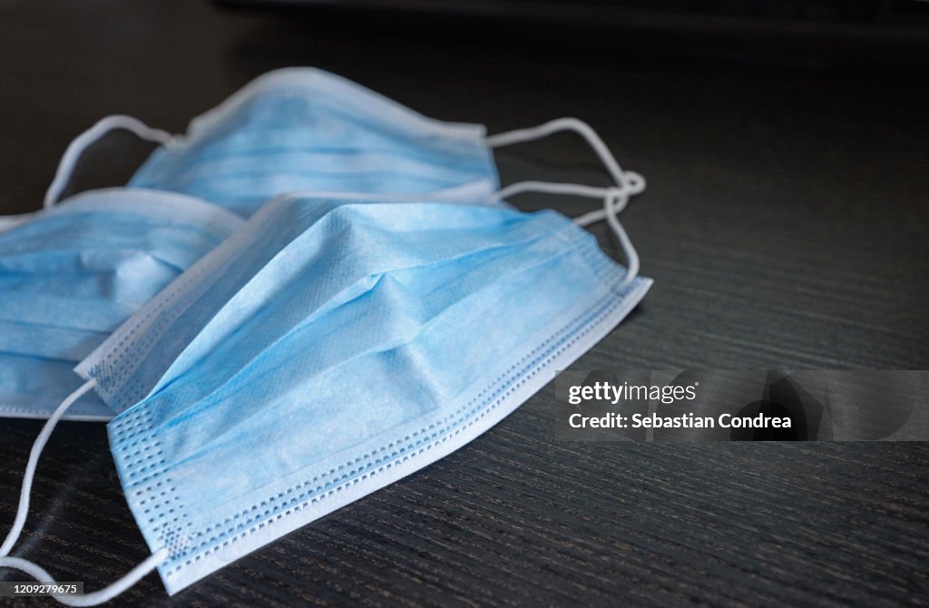 Respiratory mask on desk in office, Protective medical mask with 2019-nCoV, Coronavirus protection concept.