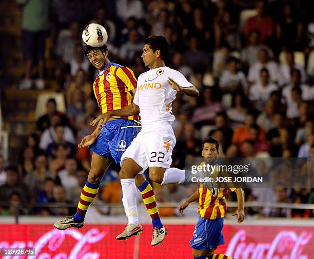 Valencia's defender Angel Dealbert heads the ball as he vies with AS Roma's forward Marco Borriello during their Naranja Trophy football match at the...