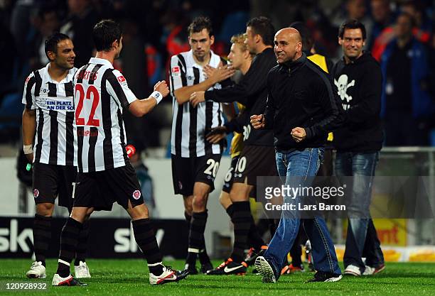 Head coach Andre Schubert of Pauli celebrates with Fin Bartels and other players after winning the Second Bundesliga match between VfL Bochum and FC...
