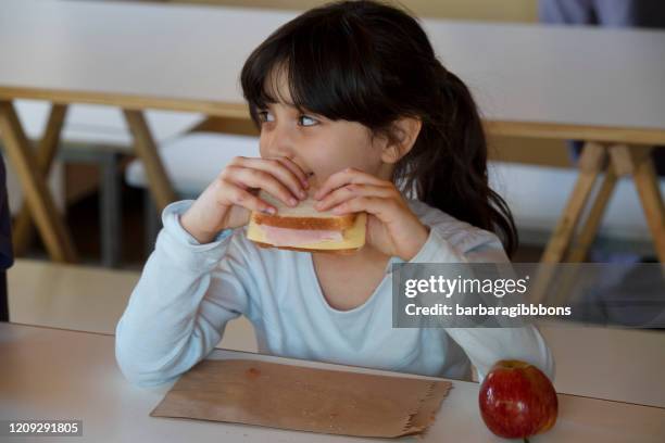 girl at school having lunch. - boarding school children stock pictures, royalty-free photos & images