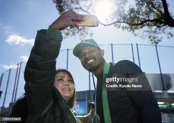 Woman takes a selfie with Orix Buffaloes outfielder Adam Jones in Miyazaki, southwestern Japan, on Jan. 31, 2020.