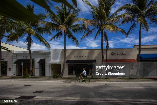 Person rides a bicycle through Worth Avenue in Palm Beach, Florida, U.S., on Friday, April 3. 2020. With more than 10 million people across the...