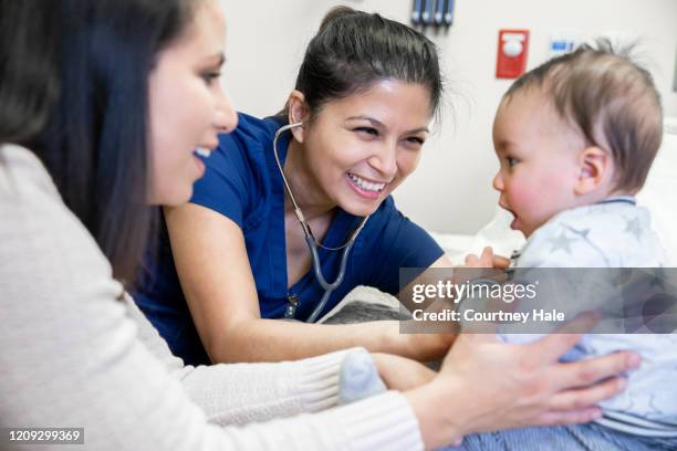 nurse checking baby boy's vitals at check up visit - filipino family stock pictures, royalty-free photos & images