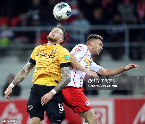 Patrick Schmidt of Dresden jumps for a header with Benedikt Saller of Regensburg during the Second Bundesliga match between SSV Jahn Regensburg and...