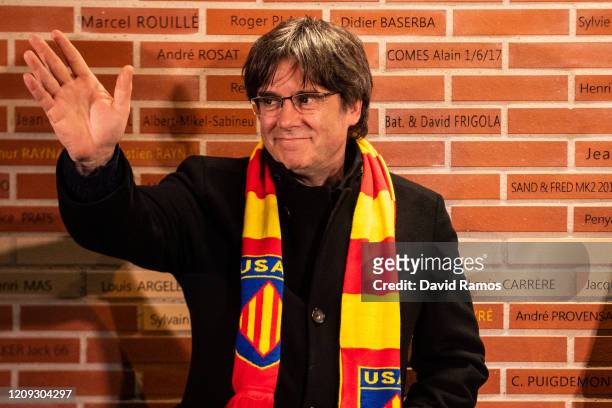 Carles Puigdemont, former President of Catalonia, waves to his supporters after unveiling a brick with his name in the USAP Legends Wall prior to the...