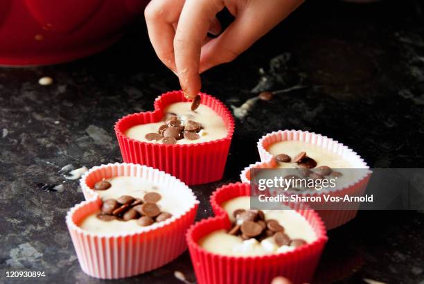 child baking heart shaped chocolate muffins - cupcake holder stock pictures, royalty-free photos & images