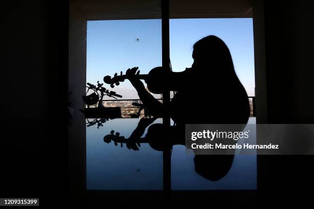 Violinist Marlly Palacios gives an online lesson through Skype on April 6, 2020 in Santiago, Chile. Palacios is a Venezuelan violinist who plays in...