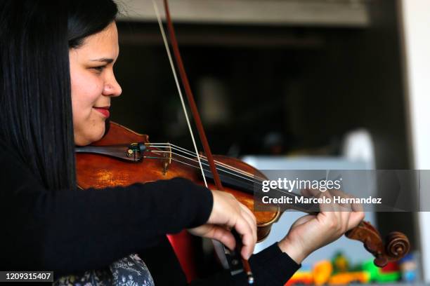 Violinist Marlly Palacios gives an online lesson through Skype on April 6, 2020 in Santiago, Chile. Palacios is a Venezuelan violinist who plays in...