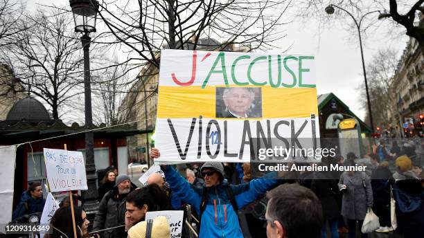 Feminist activists holding anti Polanski signs gather next to the Cesar Film Awards Ceremony to protest against the nominations of Roman Polanski's...