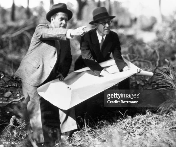 Bobby Jones appears to be very much in the rough on his perfect golf course being laid out. He and Wendell Miller , New York engineer, are going over...