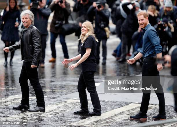 Jon Bon Jovi and Prince Harry, Duke of Sussex along with members of the Invictus Games Choir recreate the iconic Beatles 'Abbey Road' album cover...