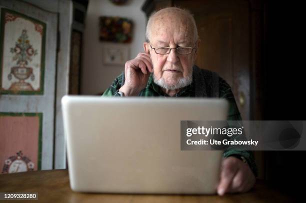 In this photo illustration an old man is looking at a laptop, computer. HEIDELBERG, GERMANY on February 14, 2020 in Heidelberg, Germany.